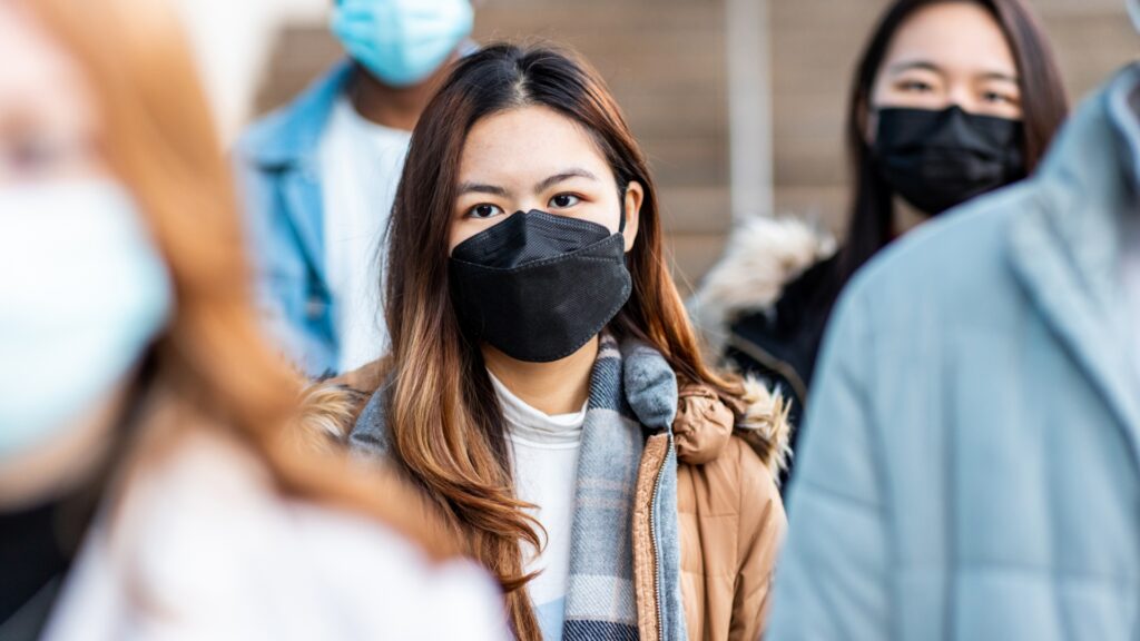 A group of people wearing masks to protect against the spread of Covid-19.