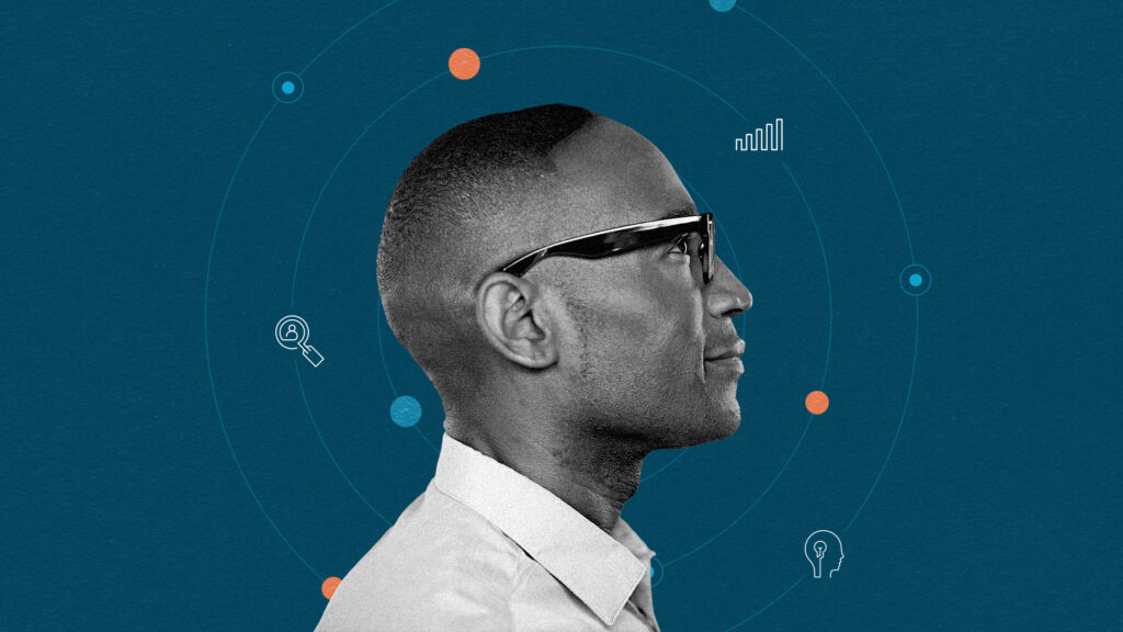 A profile of a man wearing glasses against a dark blue background with icons of a lightbulb, a graph, and a magnifying glass.