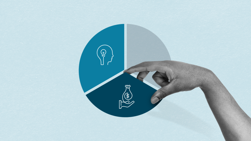 A hand adds the second piece of a pie chart containing a graphic of a hand holding a bag containing a dollar sign on it.