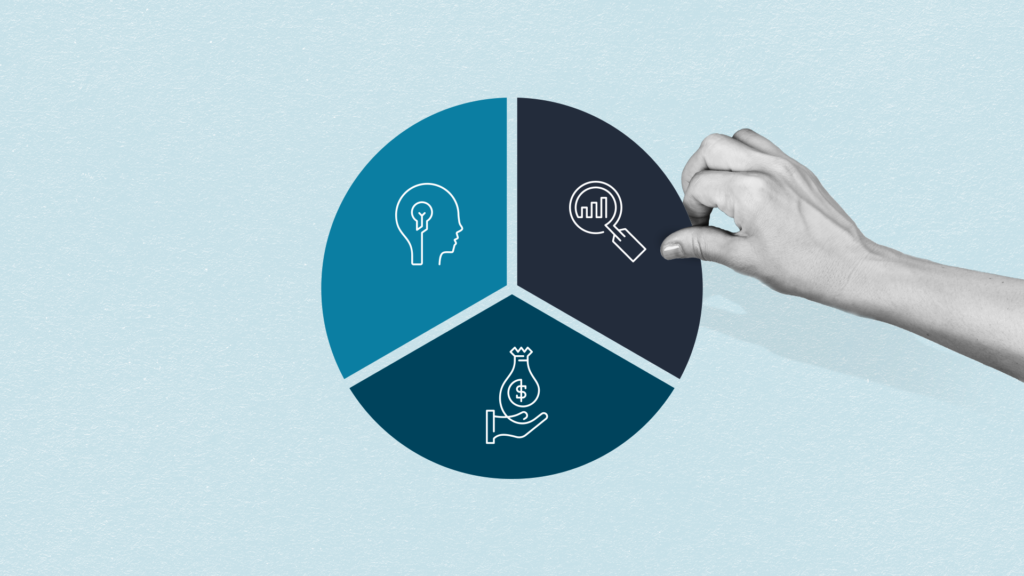 A hand adds the final piece of a pie chart containing a graphic of a magnifying glass over a bar graph.