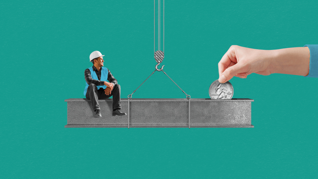 A construction worker sits on one side of a steel beam while a hand drops a quarter into the other side.