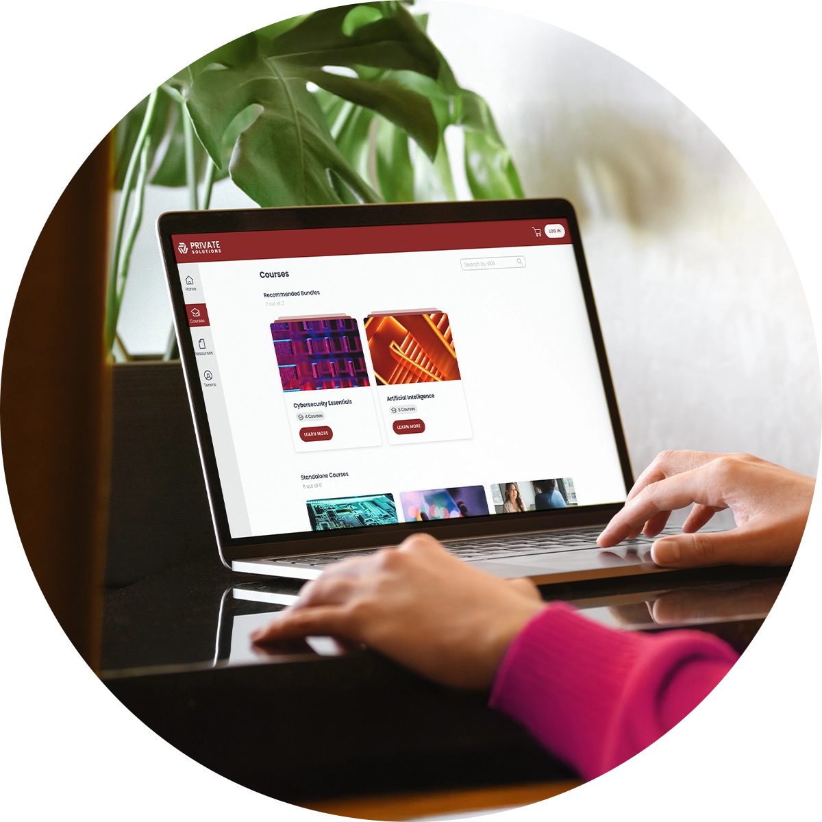 A closeup of hands typing on a laptop with information about a sample university's courses on the screen.