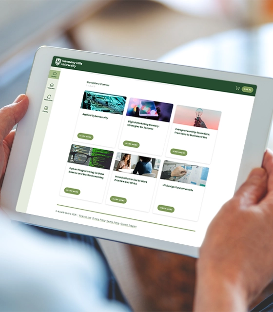 A closeup of hands holding a tablet that displays a sample university's courses on the screen.