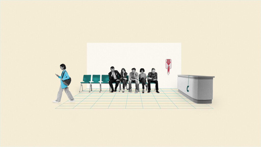 A group of people sit in a waiting room beside a sign that says "Take a number" and an unoccupied reception desk with a phone hanging off the hook.