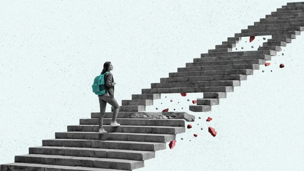 A student wearing a backpack walks up a stone staircase that has holes in it.