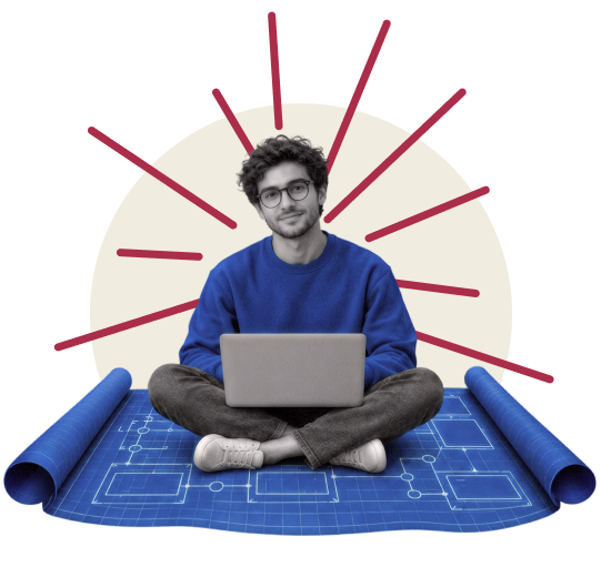 A student sits cross-legged with a laptop atop a large blueprint.